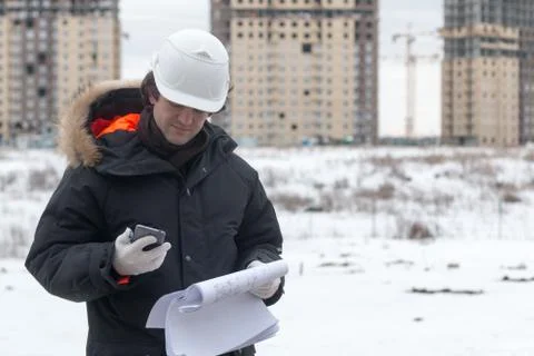Engineer or Architect with protective safety helmet checking architectural Stock Photos