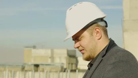 Engineer or architect on a rooftop construction site Stock Footage 323165711