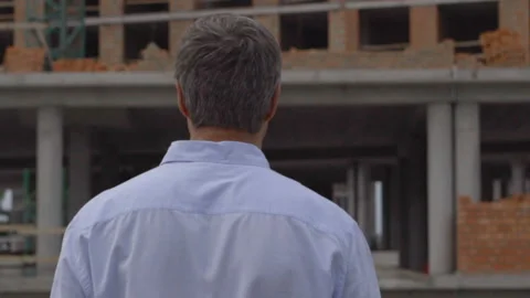 The engineer or the builder checks and controls the object under construction Video stock 111592765