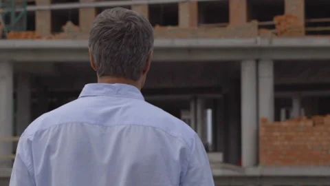 The engineer or the builder checks and controls the object under construction Stock Footage 111996301