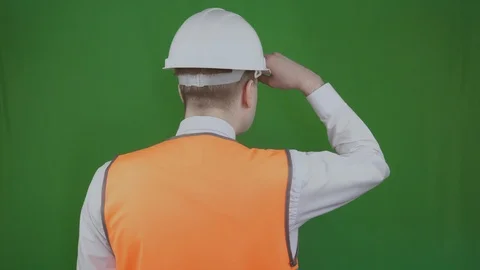 Engineer or builder stands with his back and looks at the construction works Stock Footage 113100346