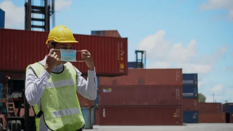 Engineer or construction worker wearing a hard hat and Face mask While working Stock Footage 135898697