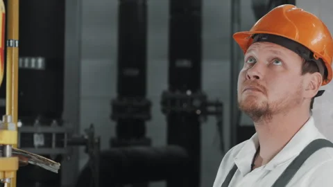 An engineer or factory worker in work uniform uses a digital tablet. Stock Footage 306815472