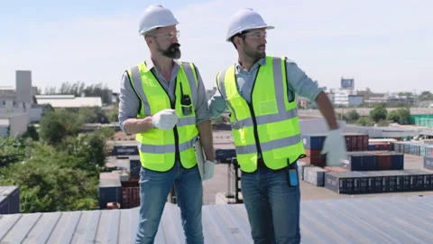 Engineer or foreman worker work and discuss together on top of cargo container Stock Footage 146432802