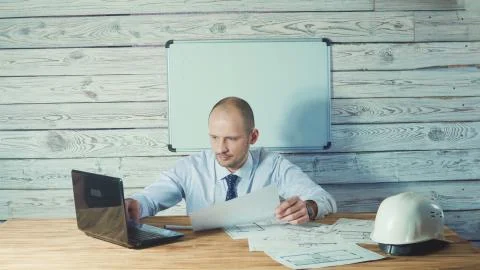 Engineer or foreman working with project documentation in the office. Stock Photos