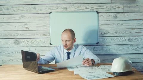 Engineer or foreman working with project documentation in the office. Stock Photos