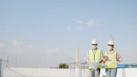 Engineer or inspector team walk and talk planning on blueprint Stock Footage 146027405