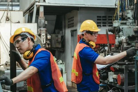 Engineer or mechanical worker  checking on production in a factory. Stock Photos
