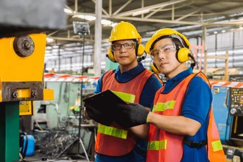 Engineer or mechanical worker  checking on production in a factory. Stock Photos