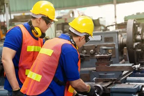 Engineer or mechanical worker  checking on production in a factory. Stock Photos