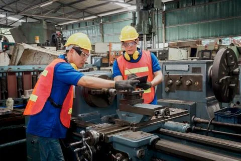 Engineer or mechanical worker checking on production in a factory. Stock Photos