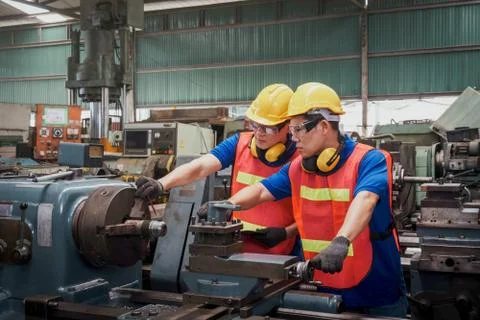 Engineer or mechanical worker  checking on production in a factory Stock Photos