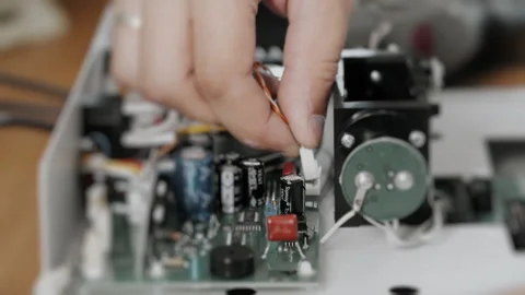 An engineer or technician attaches a cable to a computer board. Stock Footage 284295150