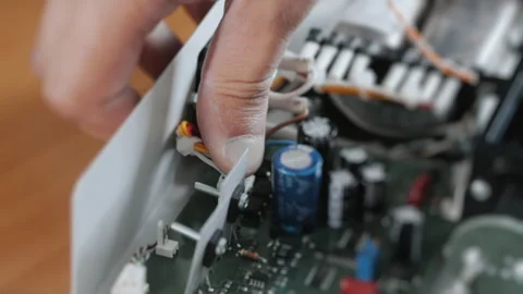 An engineer or technician attaches a cable to a computer board. Stock Footage 284295429