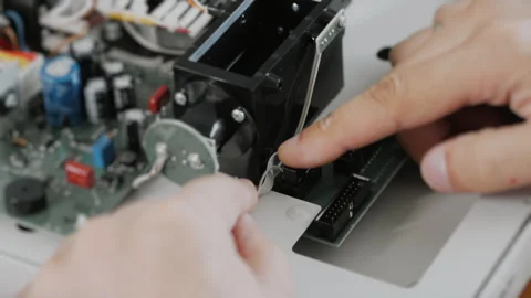 An engineer or technician attaches a cable to a computer board. Stock Footage 284295617