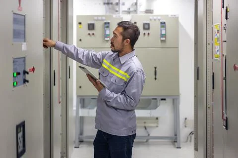 Engineer or technician man using tablet to monitor process, business, and ind Stock Photos