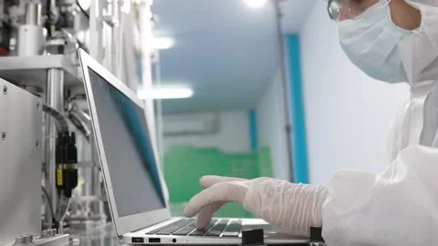 Engineer or technician in protective suite with medical face mask typing compute Stock Footage 158468811