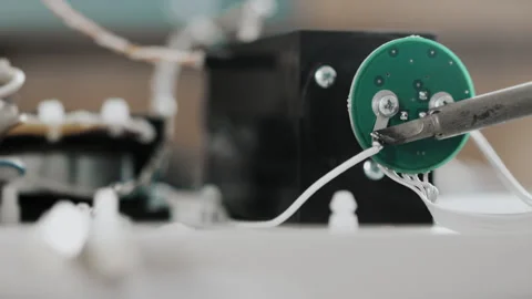 An engineer or technician solders a wire to a pin on a board. Stock Footage 284295184