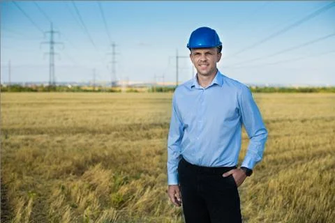 Engineer or worker smiles in protective helmet Stock Photos