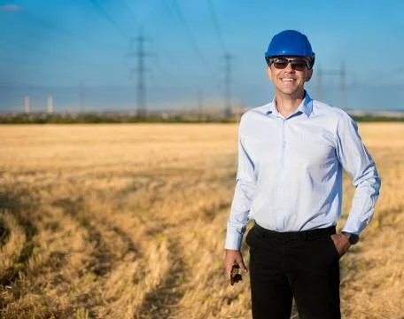 Engineer or worker smiles in protective helmet Stock Photos