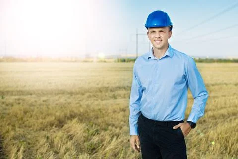 Engineer or worker smiles in protective helmet Stock Photos