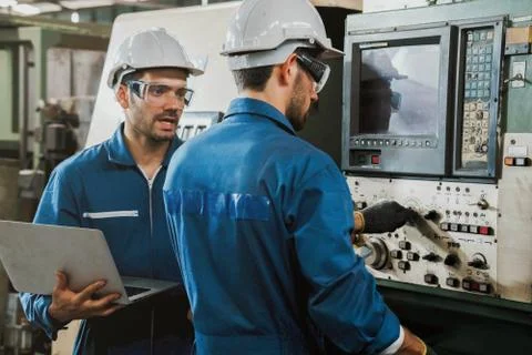 Engineer or worker with white safety helmet checking on production in a factory. Stock Photos