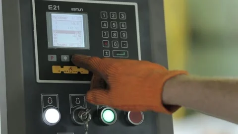 Engineer in orange gloves turns on and enters password Stock Footage 139104461