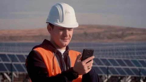 Engineer in an orange vest trying to contact workers to report deficiencies in Video stock 105916323