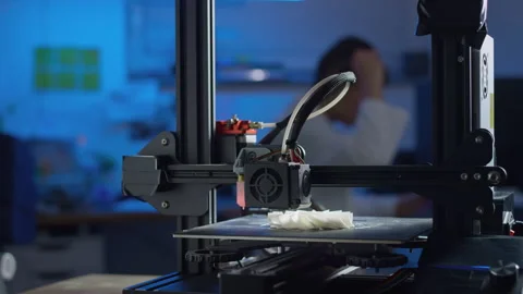 Engineer oversees 3D printer in lab for precision tasks Stock Footage 329889391