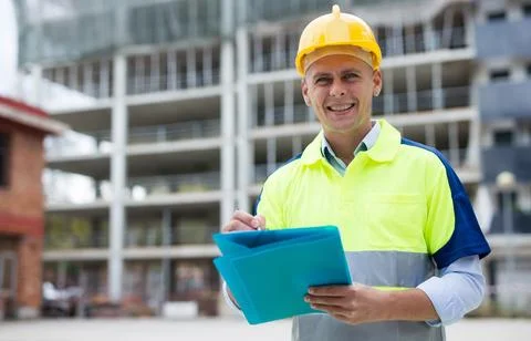 Engineer with paper folder in construction site Stock Photos