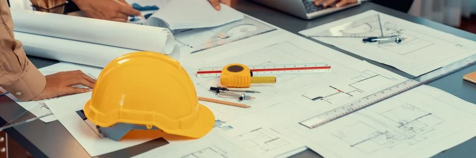 Engineer partner drawing and working on blueprint design together. Insight Stock Photos