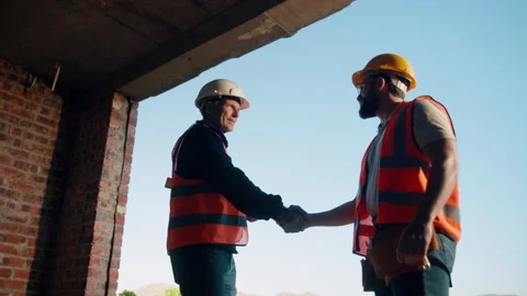 Engineer, people and handshake on construction site with collaboration, deal or Stock Footage 336211088
