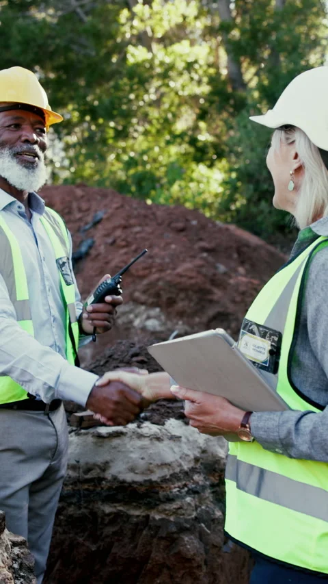 Engineer, people and handshake at construction site for greeting, excavation Stock Footage 340450308