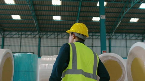 Engineer people are putting a protective helmet on  head in warehouse Видео 158174590