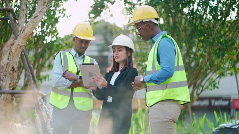 Engineer people looking at tablet and discuss on work at site Stock Footage 168563830
