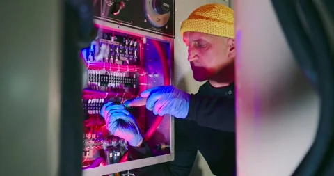 Engineer Performs Maintenance in Vibrant Engine Room Stock Footage 323749769