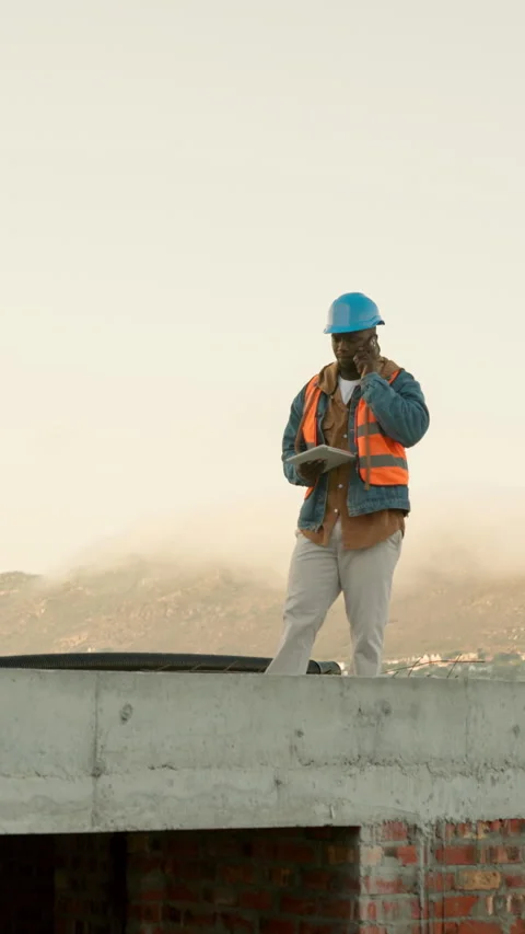 Engineer, phone call and tablet with black man on rooftop for property Stock Footage 340965765