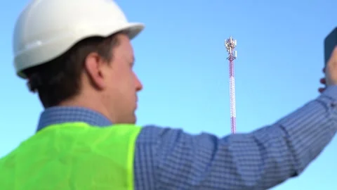 An engineer photographs a telecom tower for a report. Catches the connection Stock Footage 156994074