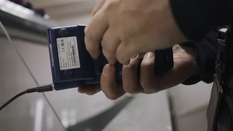 The engineer picks up the payment terminal and disassembles it Stock Footage 152913055