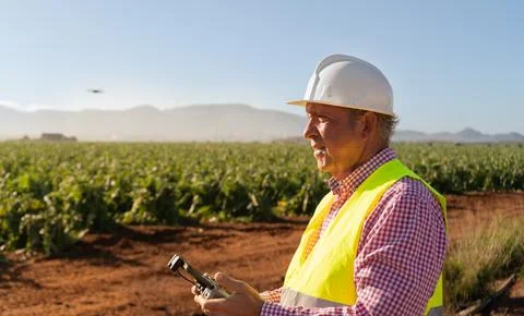 Engineer piloting a drone for the quality inspection and irrigation system .. Stock Photos