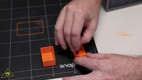 Engineer placing tools in plastic box constructed by 3D printing Видео 205196224