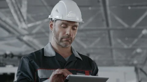 Engineer Plan of Manufacture Work Close-up. Caucasian People in Safety Hard Hat Stock-Footage 199475949