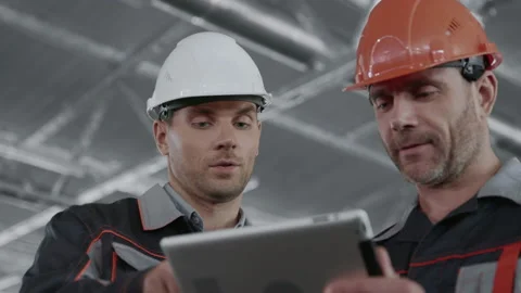 Engineer Plan of Manufacture Work. Male People in Hardhat or Safety Wear. Commun Stock Footage 199476092