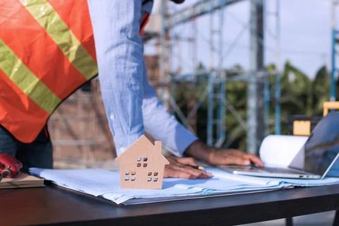 Engineer planing and working on table in construction working site Stock Photos