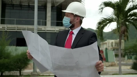 Engineer Planning Manufacturing Working face mask with blueprint. Male Stock Footage 163372503
