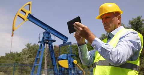 Engineer Planning Using Digital Tablet Oil Pump Platform Petroleum Rig Pumping Stock Footage 54658194