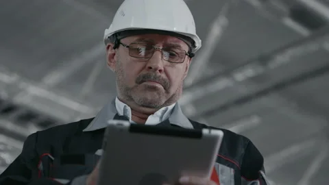 Engineer Planning Work of Machinery Manufacture. Male Person in Protective Hardh Stock Footage 199476002