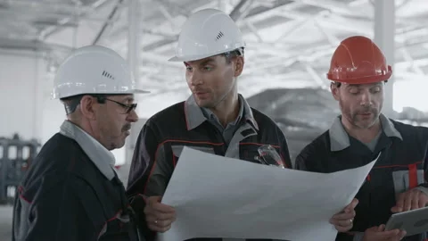 Engineer Planning Work of Machinery Manufacture. Male Person in Protective Hardh Stock Footage 199476102