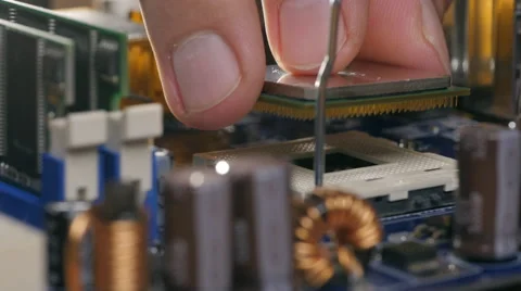 Engineer plug in CPU microprocessor to motherboard socket Video stock 68367644