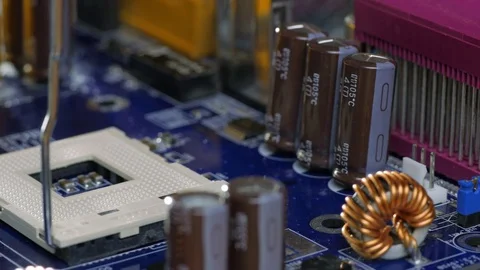 Engineer plug in CPU microprocessor to motherboard socket Stock Footage 70256901